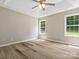 Bright bedroom with hardwood flooring, neutral walls, and ample natural light from the windows at 6022 Windsong Way, Wingate, NC 28174