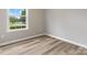 A bright bedroom with wood floors and a window offering natural light and a view of the outdoors at 6022 Windsong Way, Wingate, NC 28174
