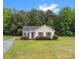 Charming single-story home with vinyl siding, blue front door, and manicured landscaping at 6022 Windsong Way, Wingate, NC 28174