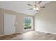 Bright, airy living room featuring wood floors, a ceiling fan, and a large window with natural light at 6022 Windsong Way, Wingate, NC 28174