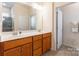 Bathroom features double sinks, wood cabinets and a glass door shower at 640 Mackenzie Falls Dr, Fort Mill, SC 29715