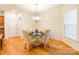 Dining room features a glass table and four upholstered chairs, with wood flooring at 640 Mackenzie Falls Dr, Fort Mill, SC 29715