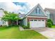 Beautiful front exterior with brick accents, a lush green lawn, and a welcoming two-car garage at 640 Mackenzie Falls Dr, Fort Mill, SC 29715
