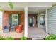 Inviting front porch with brick columns, seating area, and a view of the landscaped front yard at 640 Mackenzie Falls Dr, Fort Mill, SC 29715