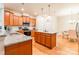 Spacious kitchen with wooden cabinets, granite countertops, stainless steel appliances, and a dining area at 640 Mackenzie Falls Dr, Fort Mill, SC 29715