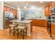 Spacious kitchen boasts stainless steel refrigerator, granite countertops, an island and hardwood floors at 640 Mackenzie Falls Dr, Fort Mill, SC 29715