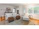 Comfortable living room featuring neutral decor, a bright window, and access to other rooms at 640 Mackenzie Falls Dr, Fort Mill, SC 29715