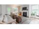 Cozy living room with fireplace, neutral tones, and access to outdoor space with lots of natural light at 640 Mackenzie Falls Dr, Fort Mill, SC 29715