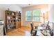 Bright office with hardwood floors features large bookshelves and a computer desk at 640 Mackenzie Falls Dr, Fort Mill, SC 29715