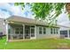 Back exterior view of the home with a screened porch and well-maintained lawn at 640 Mackenzie Falls Dr, Fort Mill, SC 29715
