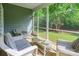 Inviting screened porch with wicker seating and a view of the landscaped backyard at 640 Mackenzie Falls Dr, Fort Mill, SC 29715