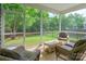 Relaxing screened porch with wicker furniture overlooks the backyard at 640 Mackenzie Falls Dr, Fort Mill, SC 29715