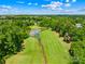 A beautiful aerial view of the golf course and the pond with the lush green trees all around at 6429 Terrace View Ct, Charlotte, NC 28269