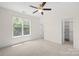 Bright bedroom with neutral carpet, ceiling fan, and a large window offering great natural light at 6429 Terrace View Ct, Charlotte, NC 28269