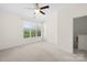 Spacious bedroom with ceiling fan, large window, and neutral carpet providing a serene retreat at 6429 Terrace View Ct, Charlotte, NC 28269