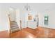 Hardwood dining area open to the kitchen, featuring a chandelier and staircase to the upper level at 6429 Terrace View Ct, Charlotte, NC 28269