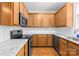 Well-lit kitchen featuring granite countertops, stainless steel appliances, and ample cabinet space at 6429 Terrace View Ct, Charlotte, NC 28269