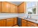 Well-lit kitchen features granite counters, tile backsplash, stainless steel appliances, and wood cabinets at 6429 Terrace View Ct, Charlotte, NC 28269