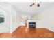 Spacious living room with hardwood floors, fireplace, and staircase, creating an inviting atmosphere at 6429 Terrace View Ct, Charlotte, NC 28269