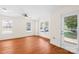 Spacious living room with hardwood floors, a ceiling fan, and a door to the backyard at 6429 Terrace View Ct, Charlotte, NC 28269