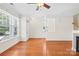Inviting living room with hardwood floors, natural light, and a fireplace, with easy access to the staircase at 6429 Terrace View Ct, Charlotte, NC 28269