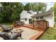Backyard deck with patio seating, a fire pit, and a well maintained backyard at 6824 Cortez Trl, Charlotte, NC 28227