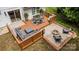 Stunning backyard deck featuring a fire pit, lounge seating, and elegant outdoor decor at 6824 Cortez Trl, Charlotte, NC 28227
