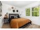 Comfortable bedroom with a cozy queen bed and natural light from the window at 6824 Cortez Trl, Charlotte, NC 28227