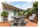 Outdoor deck area with patio furniture set and greenery creating inviting space for relaxing and entertaining at 6824 Cortez Trl, Charlotte, NC 28227