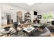 Open dining room features seating for six, a modern light fixture, and leads to a well-lit living space at 6824 Cortez Trl, Charlotte, NC 28227