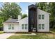 Two-story house with a black accent wall, windows, a front door, and a small porch with chair at 6824 Cortez Trl, Charlotte, NC 28227