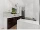 Modern kitchen features white countertops and backsplash, stainless steel appliances, and dark cabinets at 6824 Cortez Trl, Charlotte, NC 28227