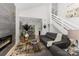 Spacious living room featuring a fireplace, modern decor, and an open layout with a staircase at 6824 Cortez Trl, Charlotte, NC 28227