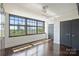 Well-lit bedroom featuring a large window, hardwood floors, and a modern closet space at 715 N Graham St # 603, Charlotte, NC 28202