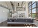 Contemporary kitchen with island seating, stainless steel appliances, and large windows at 715 N Graham St # 603, Charlotte, NC 28202