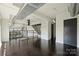 Living room featuring hardwood floors, industrial ductwork, a staircase, and large windows at 715 N Graham St # 603, Charlotte, NC 28202