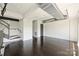 Minimalist living room with hardwood floors, industrial piping and a staircase with metal railing at 715 N Graham St # 603, Charlotte, NC 28202