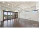 Bright living room with hardwood floors and access to a terrace featuring a fireplace and city views at 715 N Graham St # 603, Charlotte, NC 28202