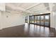 Spacious living room with dark hardwood floors and folding doors to a terrace with city views at 715 N Graham St # 603, Charlotte, NC 28202