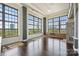 Bright living room with hardwood floors, large windows with city views, and a stone fireplace at 715 N Graham St # 603, Charlotte, NC 28202
