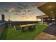 Relax on the rooftop deck with artificial turf, an outdoor dining area, and a panoramic city view at 715 N Graham St # 603, Charlotte, NC 28202