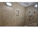 Tiled shower with a built-in niche and multiple shower heads, offering a luxurious and relaxing experience at 715 N Graham St # 603, Charlotte, NC 28202