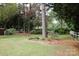 Spacious backyard featuring mature trees, green grass, and a white picket fence at 723 Rabun Ln, Rock Hill, SC 29730