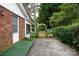 View of the home's brick exterior and a lush, landscaped backyard with an arched entrance at 723 Rabun Ln, Rock Hill, SC 29730