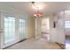 Cozy dining area featuring neutral carpet, a chandelier, and access to the kitchen at 723 Rabun Ln, Rock Hill, SC 29730