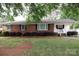 Charming brick home with black shutters and mature landscaping at 723 Rabun Ln, Rock Hill, SC 29730