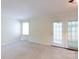 Bright living room with neutral carpet and sliding glass doors to outside at 723 Rabun Ln, Rock Hill, SC 29730