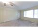 Sunny living room with tan carpet and a large window overlooking the front yard at 723 Rabun Ln, Rock Hill, SC 29730