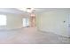 Open-concept living room and dining area with neutral carpet and natural light at 723 Rabun Ln, Rock Hill, SC 29730