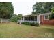 View of home's sunroom with white trim, lots of windows, and a beautiful lawn at 723 Rabun Ln, Rock Hill, SC 29730